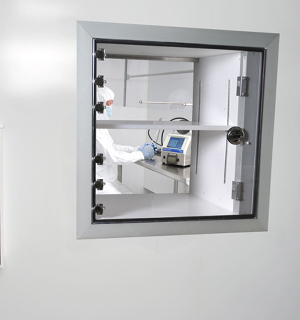 viewing a lab employee through a cleanroom window
