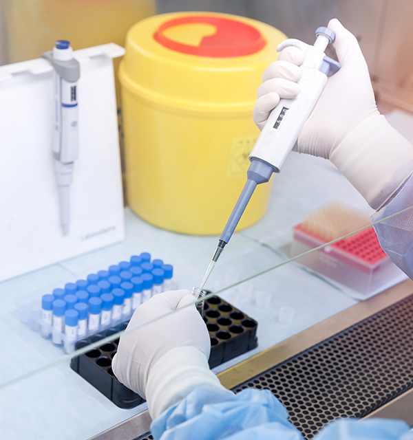 lab worker filling test tubes