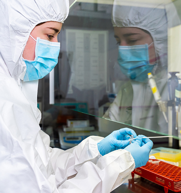 lab worker taking a sample from the end of a Q-tip